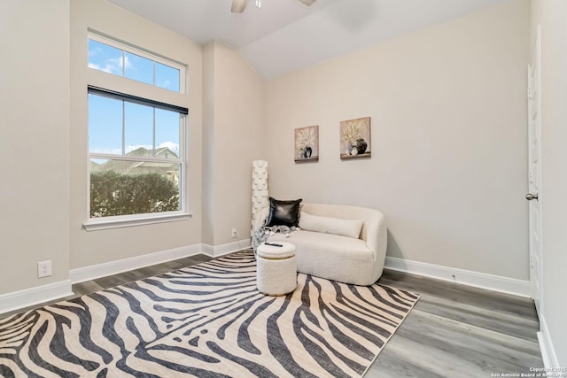 sitting room featuring lofted ceiling, ceiling fan, wood finished floors, and baseboards