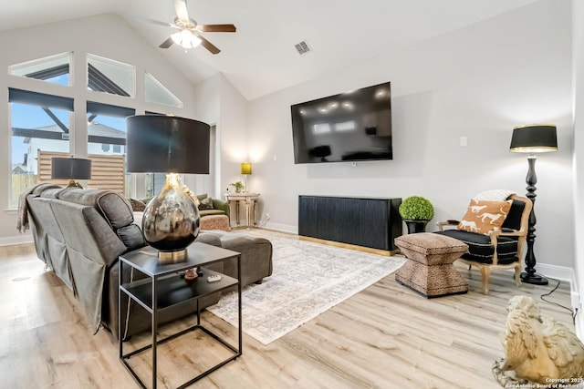 living room with a ceiling fan, visible vents, baseboards, and wood finished floors