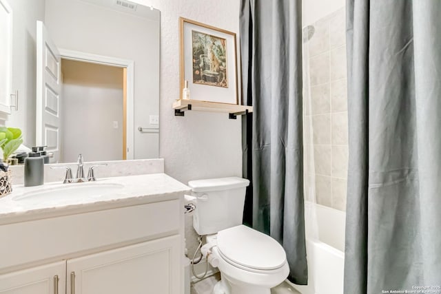 bathroom with visible vents, a textured wall, toilet, shower / tub combo with curtain, and vanity