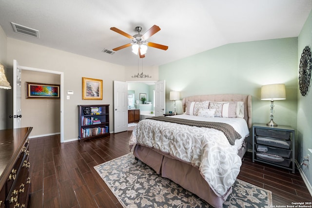 bedroom with baseboards, visible vents, vaulted ceiling, and wood finish floors