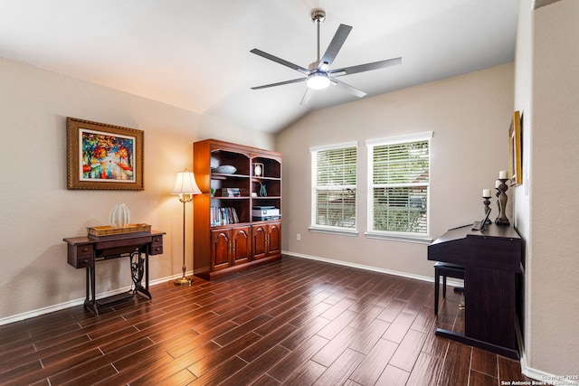 living area featuring vaulted ceiling, wood finish floors, a ceiling fan, and baseboards