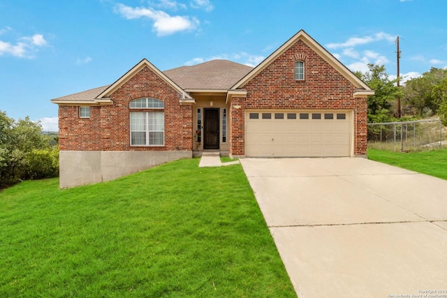 ranch-style house with brick siding, roof with shingles, concrete driveway, a front yard, and a garage