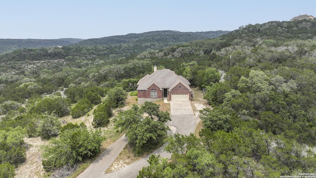 drone / aerial view featuring a forest view