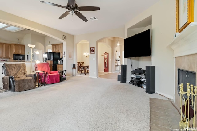 846 County Road 2763, Mico, TX 78056 - living room with visible vents, arched walkways, light colored carpet, ceiling fan, and a fireplace