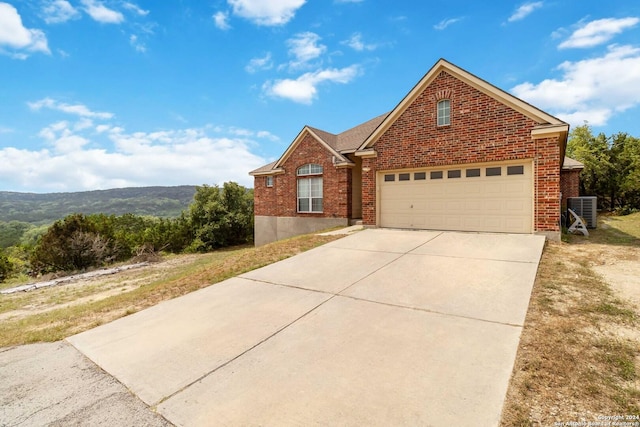 846 County Road 2763, Mico, TX 78056 - traditional-style house featuring concrete driveway, brick siding, and cooling unit