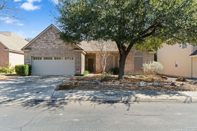 view of front of property with an attached garage, driveway, and brick siding