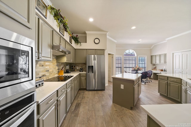 kitchen with under cabinet range hood, appliances with stainless steel finishes, and gray cabinetry