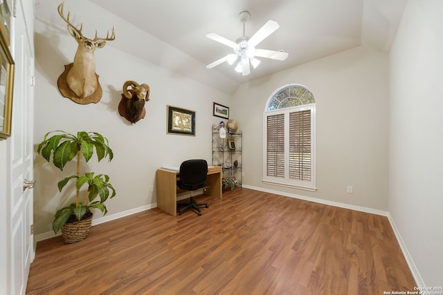 home office featuring a ceiling fan, vaulted ceiling, baseboards, and wood finished floors