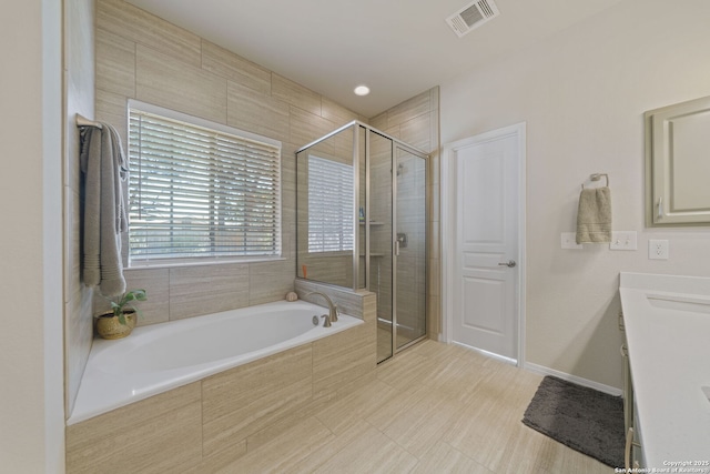 full bath with a stall shower, visible vents, vanity, and a bath