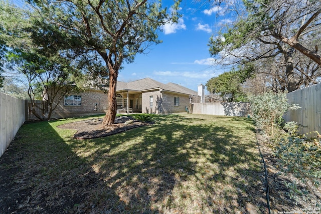 view of yard with a fenced backyard