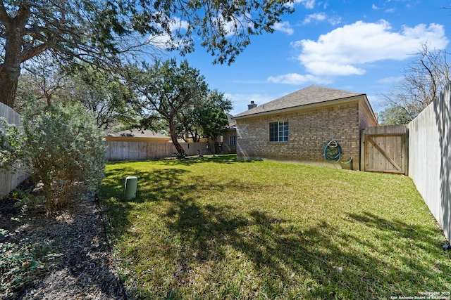 view of yard with a fenced backyard