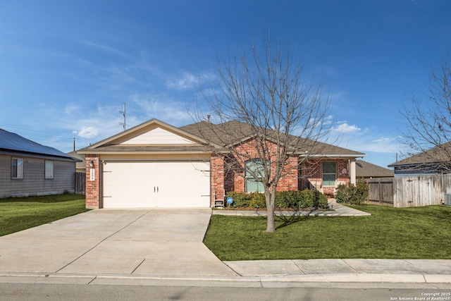 ranch-style house with a front yard, fence, concrete driveway, and brick siding