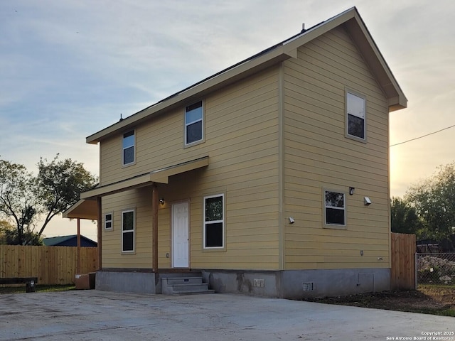 back of property featuring entry steps, crawl space, and fence