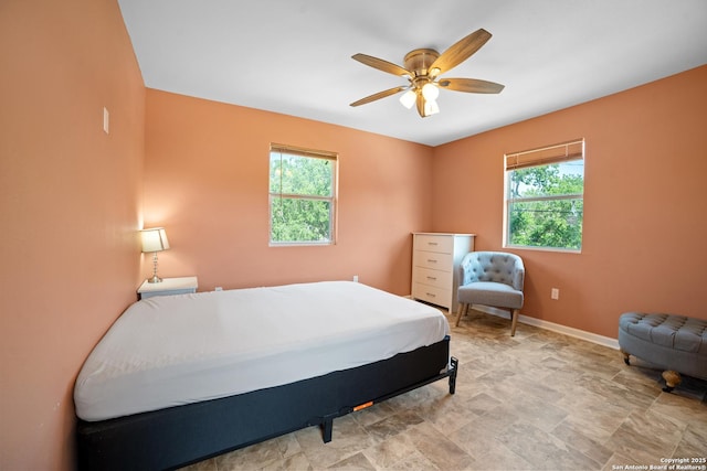 232 Hobart, San Antonio, TX 78237 - bedroom featuring baseboards, a ceiling fan, and stone finish floors