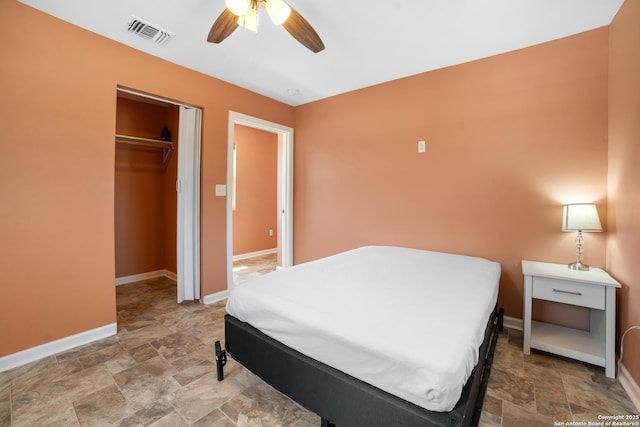 232 Hobart, San Antonio, TX 78237 - bedroom with baseboards, stone finish flooring, a ceiling fan, and a closet