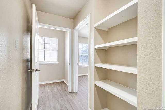 interior space featuring baseboards and wood finished floors