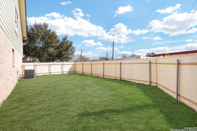 view of yard with central air condition unit and a fenced backyard