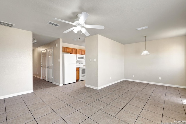 unfurnished room with ceiling fan, visible vents, and baseboards