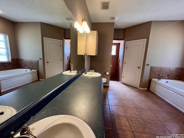 full bath with tile patterned flooring, visible vents, a garden tub, and toilet