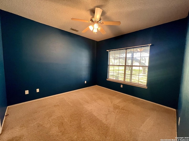 carpeted spare room featuring ceiling fan and a textured ceiling