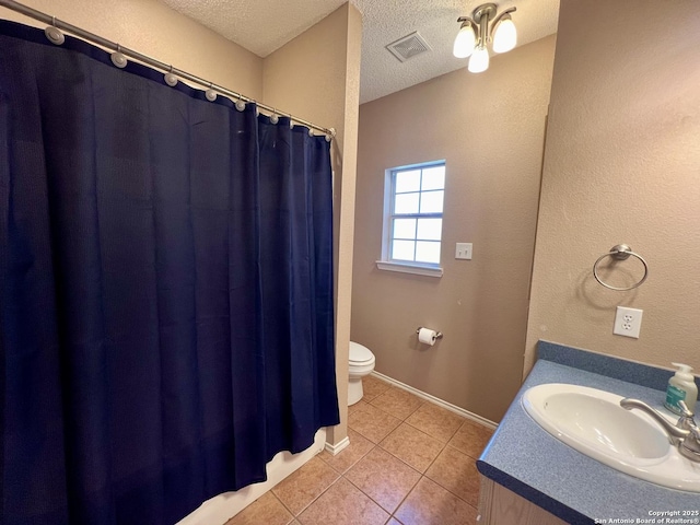 full bathroom with a textured ceiling, tile patterned flooring, toilet, vanity, and visible vents