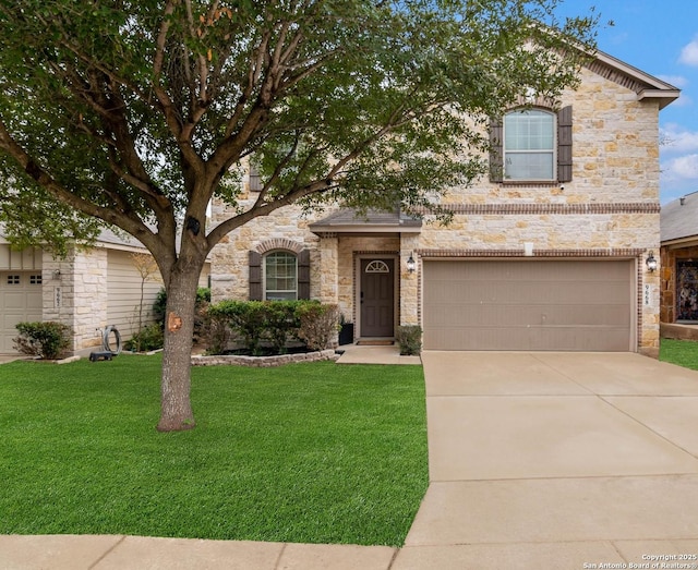 traditional-style house featuring an attached garage, driveway, a front lawn, and stone siding