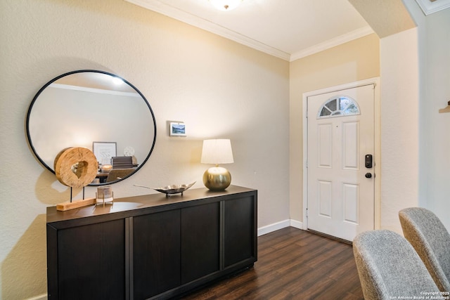 foyer with dark wood finished floors, crown molding, and baseboards