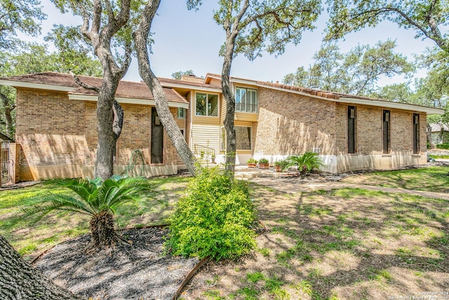 back of house with brick siding