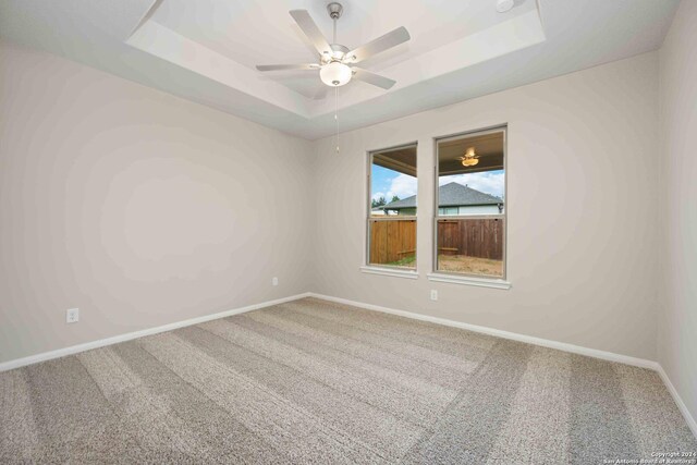 15046 Homing Mdw, San Antonio, TX 78253 - empty room featuring carpet floors, a tray ceiling, a ceiling fan, and baseboards