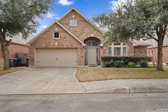 view of front facade with a garage, driveway, brick siding, and a front lawn