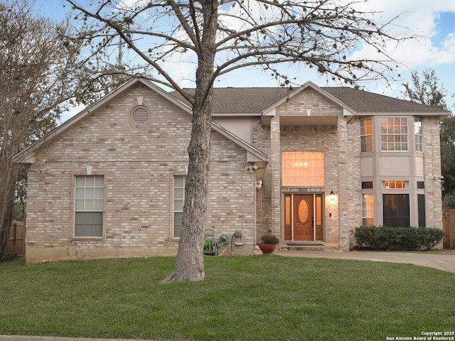 view of front of home featuring brick siding and a front yard