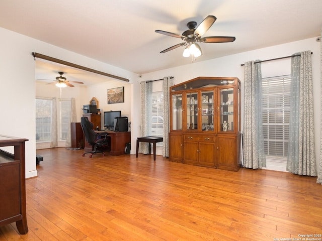 office space featuring a ceiling fan and light wood finished floors