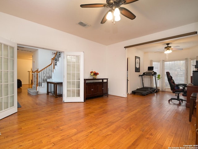 office area featuring light wood-style floors, ceiling fan, visible vents, and french doors