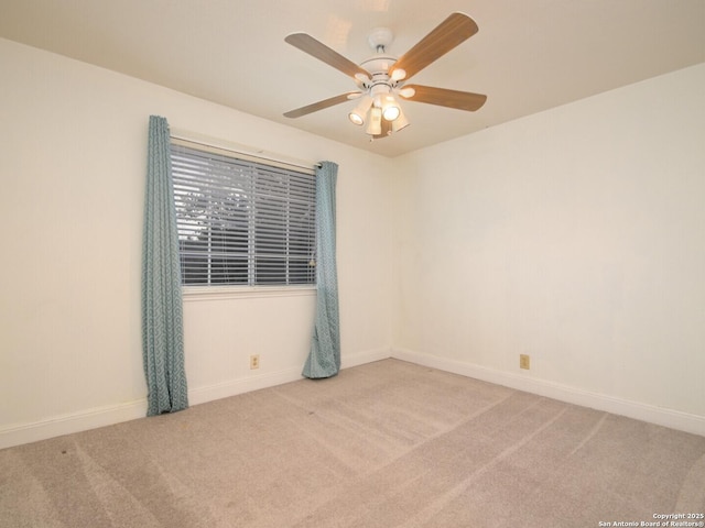 spare room featuring ceiling fan, carpet floors, and baseboards