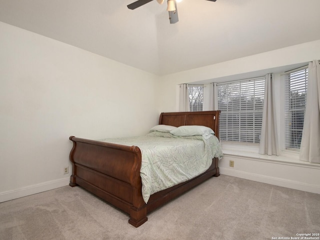 bedroom featuring carpet flooring, vaulted ceiling, baseboards, and ceiling fan