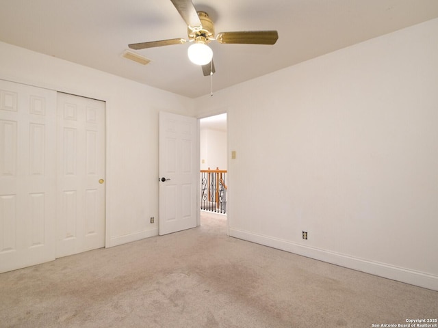 unfurnished bedroom with carpet floors, baseboards, visible vents, and a closet