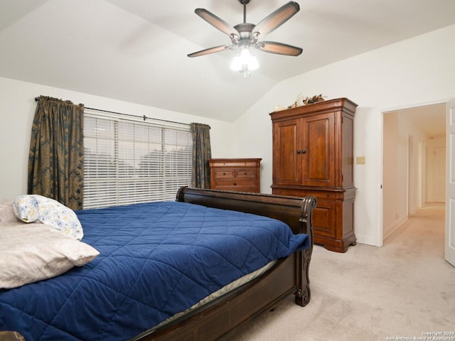 bedroom with lofted ceiling, ceiling fan, baseboards, and light colored carpet