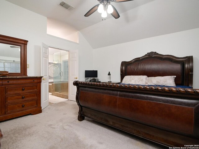 bedroom featuring connected bathroom, light carpet, visible vents, a ceiling fan, and vaulted ceiling