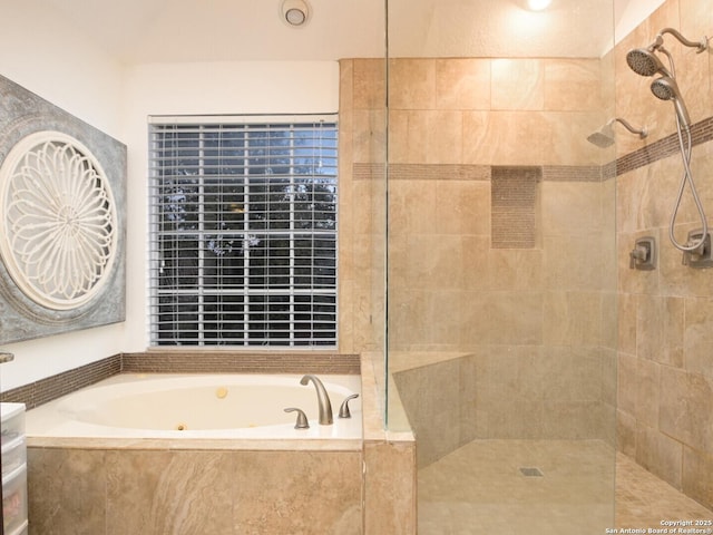 bathroom featuring a tub with jets and tiled shower