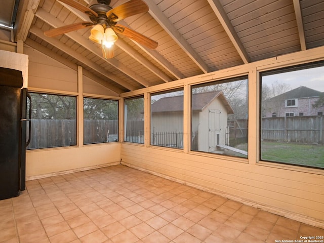 unfurnished sunroom featuring vaulted ceiling with beams, ceiling fan, and wood ceiling