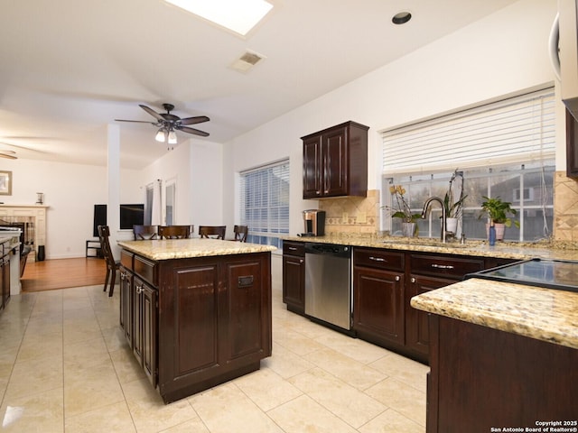 kitchen with visible vents, dishwasher, ceiling fan, backsplash, and a sink