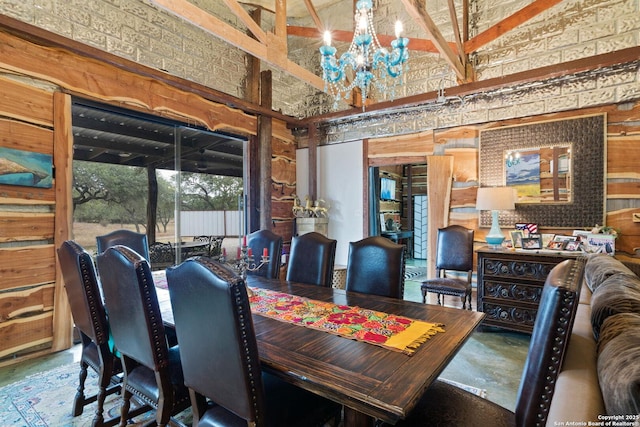 dining area with a high ceiling and an inviting chandelier