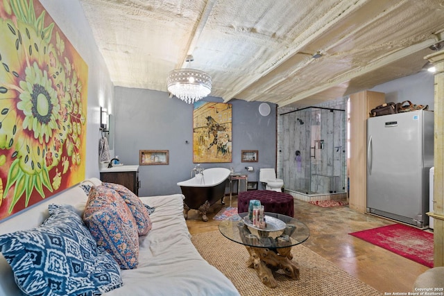 living room featuring finished concrete floors and an inviting chandelier