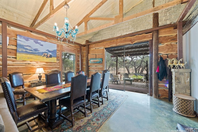 dining room with an inviting chandelier, concrete floors, and high vaulted ceiling