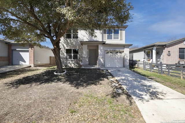 view of front of property featuring a garage, fence, and driveway