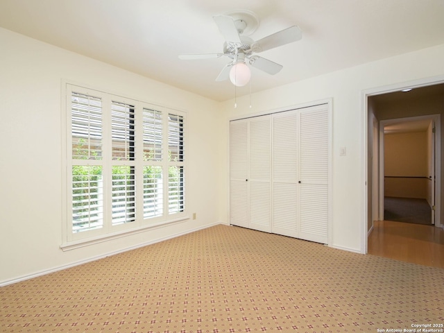 unfurnished bedroom with a ceiling fan, baseboards, and a closet