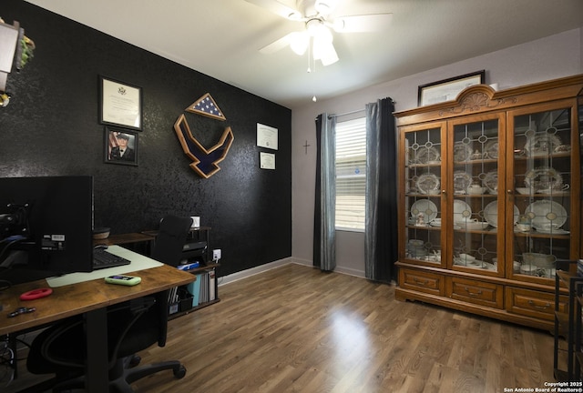 office space featuring ceiling fan, baseboards, and wood finished floors