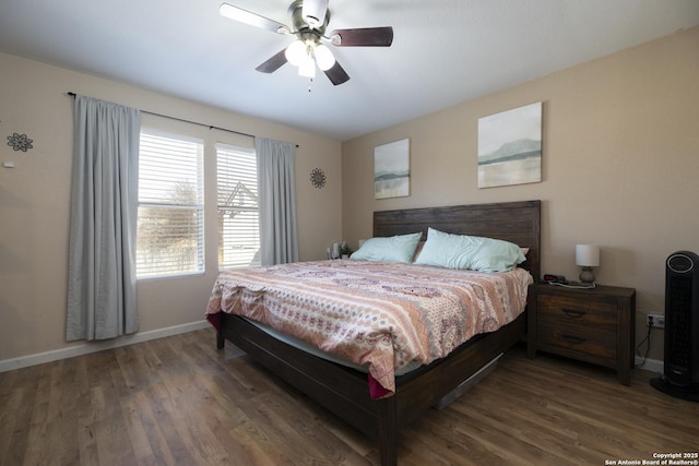 bedroom with ceiling fan, baseboards, and wood finished floors