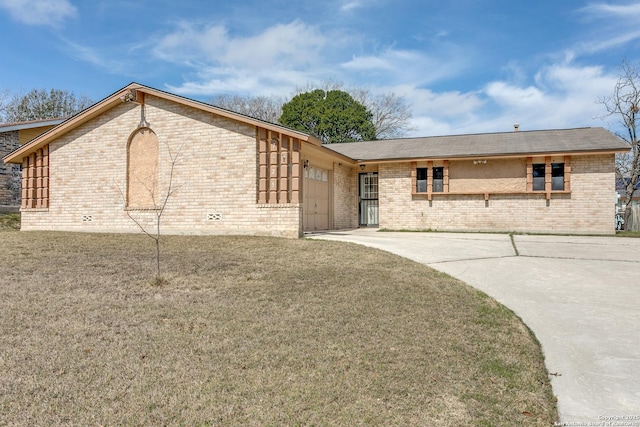 single story home with a garage, concrete driveway, brick siding, and a front lawn