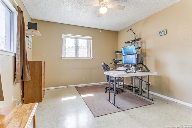 office space featuring ceiling fan, a textured ceiling, baseboards, and tile patterned floors